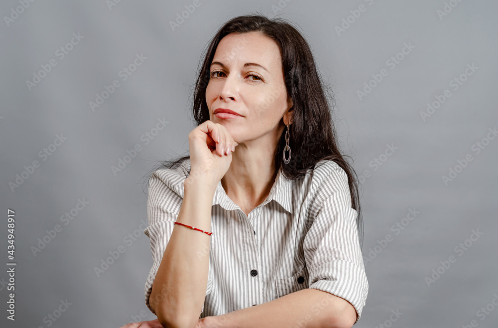 Portrait of young woman backed chin by hand Portrait of young woman backed chin by hand