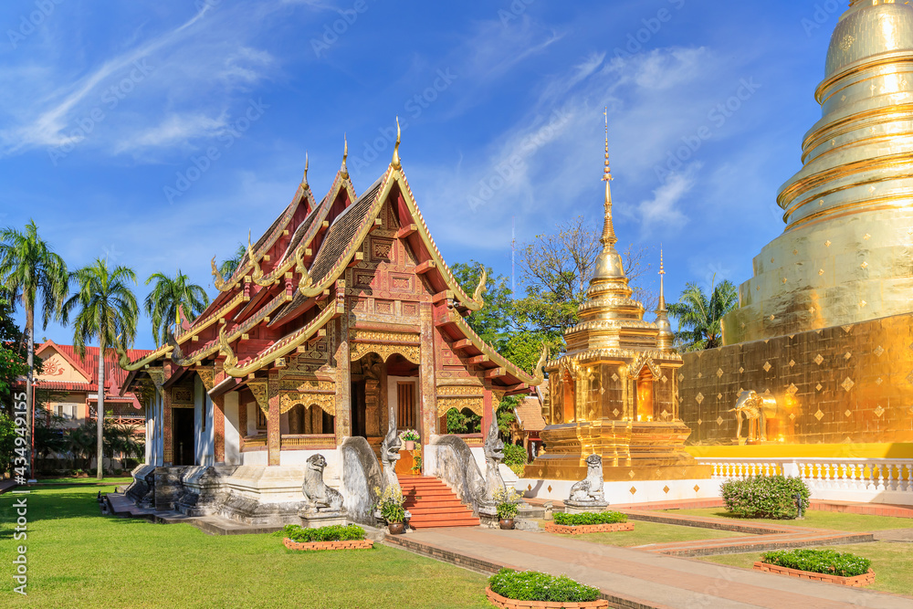 Fototapeta premium Chapel and golden pagoda at Wat Phra Singh Woramahawihan, famous travel destination in Chiang Mai, Thailand