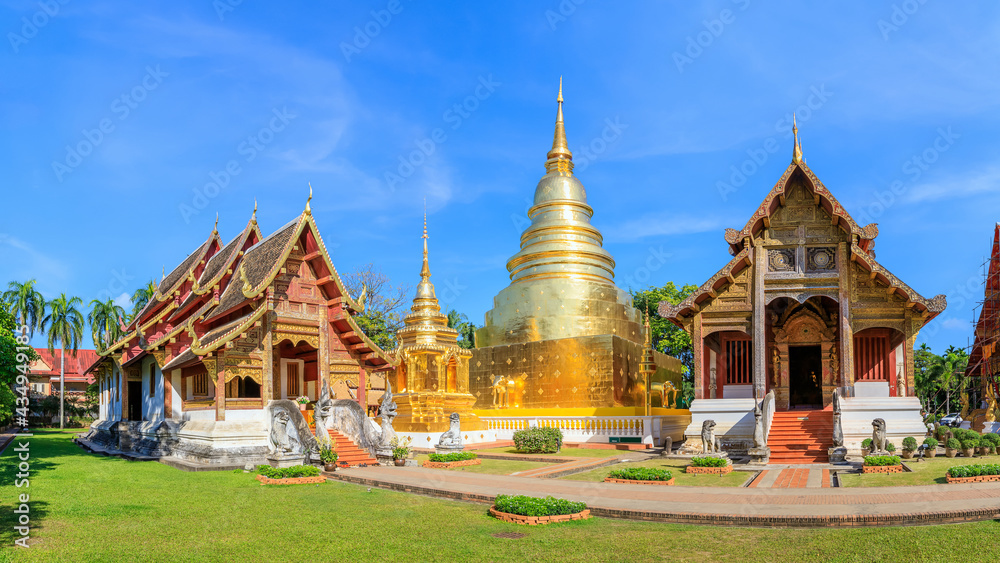 Fototapeta premium Chapel and golden pagoda at Wat Phra Singh Woramahawihan, famous travel destination in Chiang Mai, panorama
