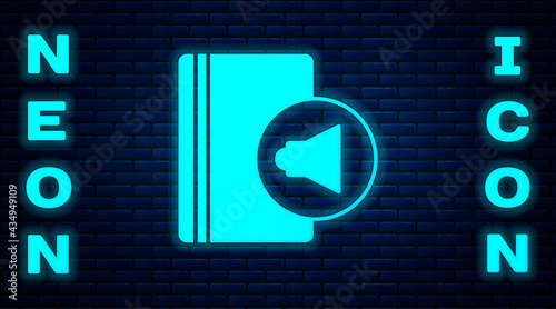 Glowing neon Audio book icon isolated on brick wall background. Book with headphones. Audio guide sign. Online learning concept. Vector