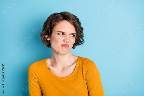 Photo of annoy nice brunette short hairdo lady look empty space wear brown shirt isolated on bright blue color background © deagreez