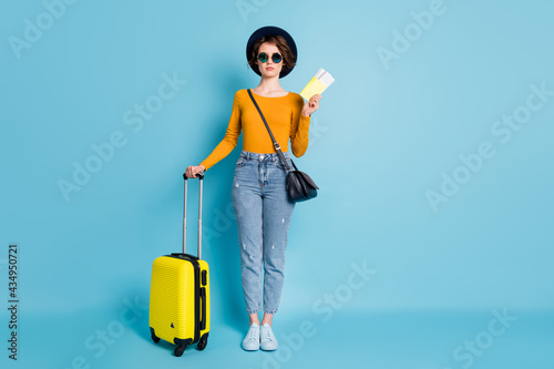 Full length body size photo of girl keeping documents luggage in airport ready to travel isolated on vibrant blue color background