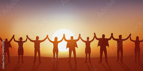 Concept de la solidarité et de l’union avec des hommes et des femmes qui se donnent la main pour former une chaîne humaine.