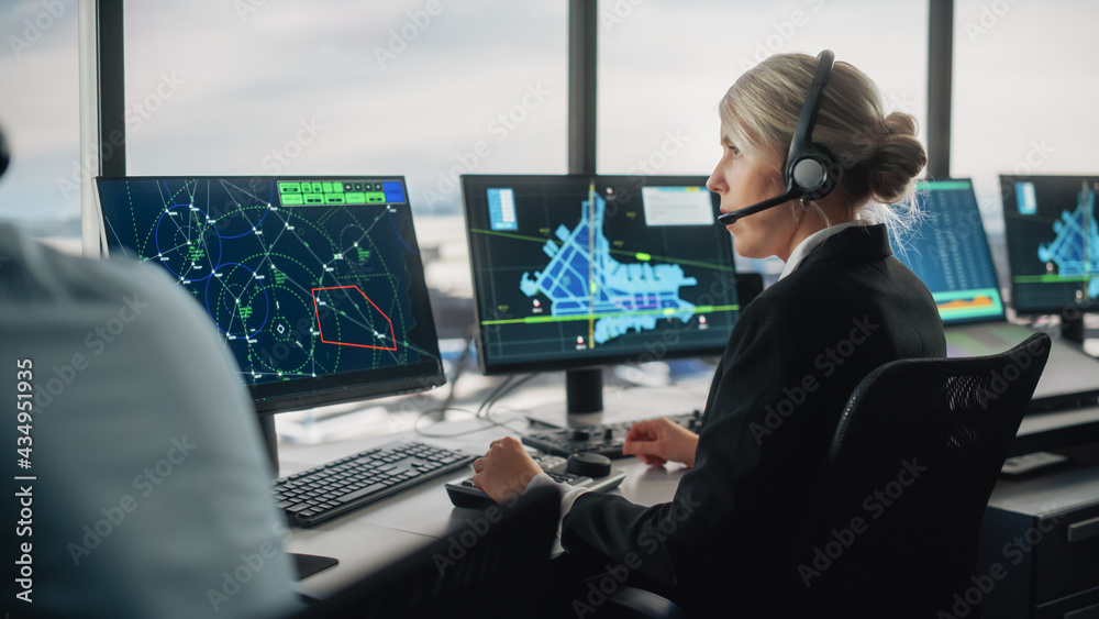 Female Air Traffic Controller with Headset Talk on a Call in Airport