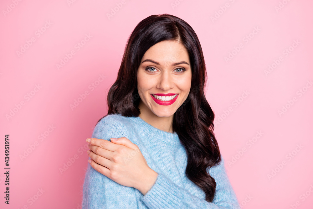 Portrait of half turned charming cheerful person hand hug shoulder isolated on pink color background Portrait of half turned charming cheerful person hand hug shoulder isolated on pink color background