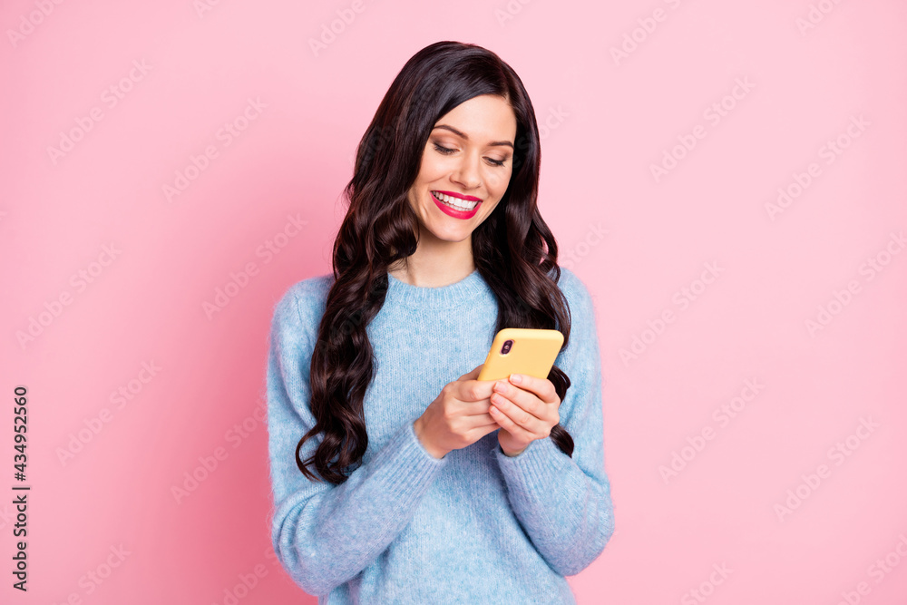 Portrait of pretty cheerful blogger beaming smile look phone wear pullover isolated on pink color background Portrait of pretty cheerful blogger beaming smile look phone wear pullover isolated on pink color background