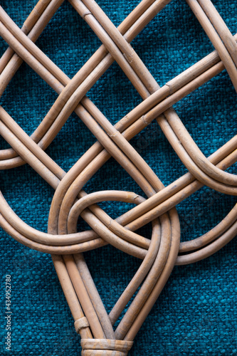 detail close-up of a carpet beater lying on blue carpet photo