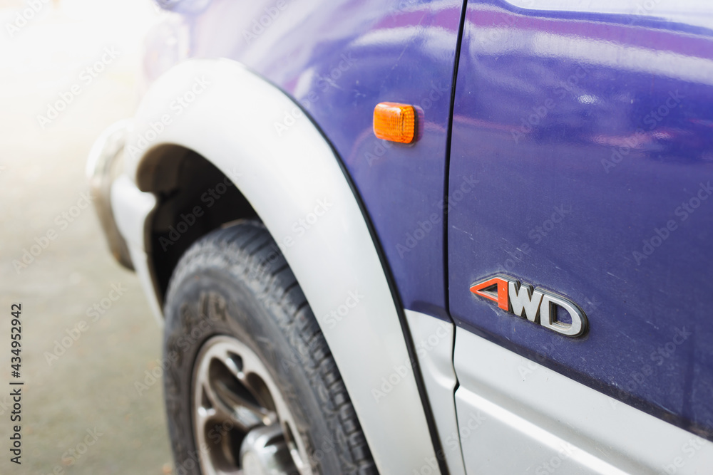 Close-up 4wd logo on blue car. Car detail 