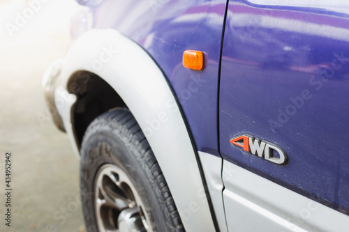 Close-up 4wd logo on blue car. Car detail 