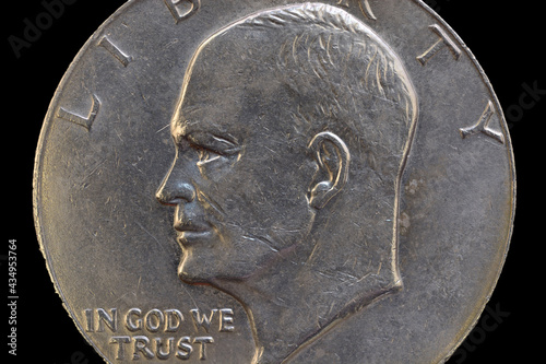 Portrait of the President of USA Dwight D. Eisenhower on the one dollar USA coin issued in 1978, isolated on the black background