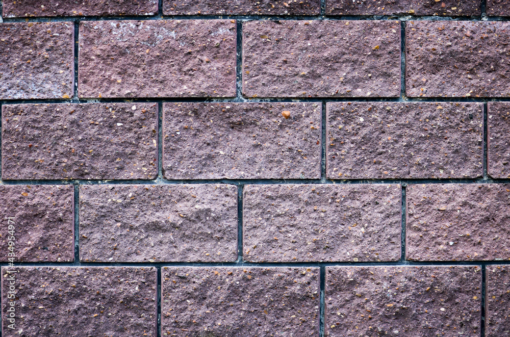 Fototapeta premium Dark brick wall - texture of stone close-up. Brick background.