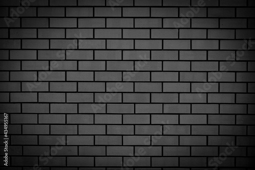 Black brick wall. Abstract background for design. Backdrop for product display.