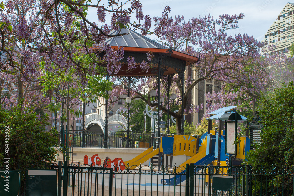 green entrance of an historic children playground with a kiosk