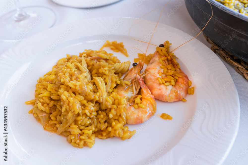 Juicy rice with onion and shrimps on a plate Juicy rice with onion and shrimps on a plate