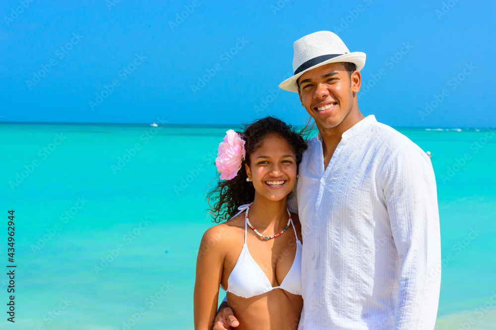 Couple on the beach, close-up smilling and hugging, interracial, black, dressed in white outfits, fun couples on the beach, young people Couple on the beach, close-up smilling and hugging, interracial, black, dressed in white outfits, fun couples on the beach, young people