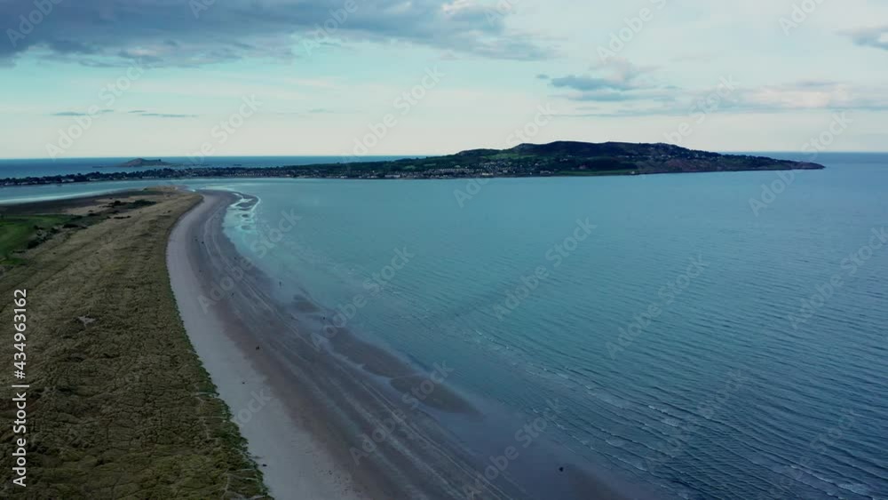 custom made wallpaper toronto digitalDrone tracking left, over the Irish landscape at golden hour. Aerial view over North Bull Island and Dollymount Strand revealing textured landscape and Howth peninsula on the horizon.