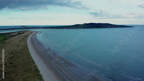 Wallpaper Mural Drone tracking left, over the Irish landscape at golden hour. Aerial view over North Bull Island and Dollymount Strand revealing textured landscape and Howth peninsula on the horizon.  Torontodigital.ca