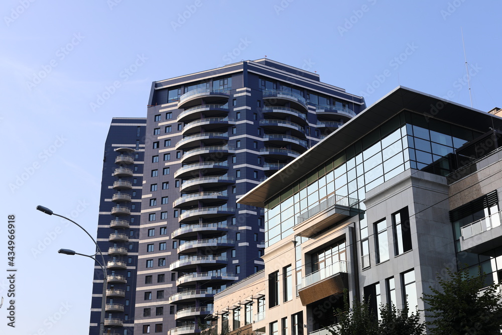 Scenic view of contemporary residential houses on a sunny day. True modern cityscape of the Ukrainian capital. Design of contemporary build in big city. Real urban style of residential building. Scenic view of contemporary residential houses on a sunny day. True modern cityscape of the Ukrainian capital. Design of contemporary build in big city. Real urban style of residential building.