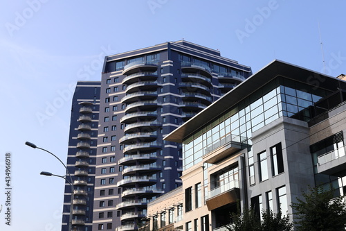 Scenic view of contemporary residential houses on a sunny day. True modern cityscape of the Ukrainian capital. Design of contemporary build in big city. Real urban style of residential building.
