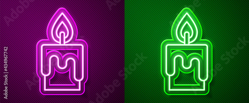 Glowing neon line Burning candle icon isolated on purple and green background. Cylindrical candle stick with burning flame. Vector
