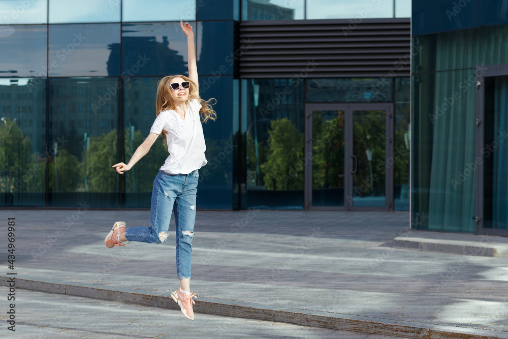 Emotional girl jumps up summer in the city Emotional girl jumps up summer in the city