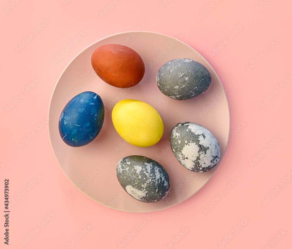 Pink ceramic plate with colorful Easter eggs in pastel colors on a pink background. Happy Easter card concept, minimalistic design, top view. Natural paint. Pink ceramic plate with colorful Easter eggs in pastel colors on a pink background. Happy Easter card concept, minimalistic design, top view. Natural paint.