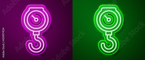 Glowing neon line Hand scale spring mechanical icon isolated on purple and green background. Vector