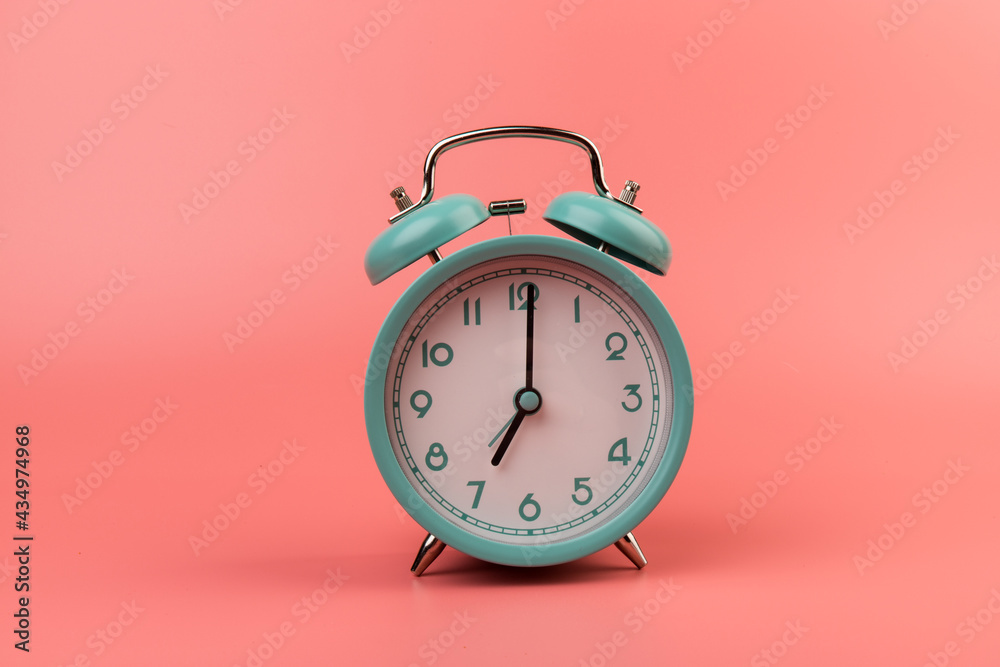 Old clock isolated on a pink background with space for text. Concept of time Old clock isolated on a pink background with space for text. Concept of time