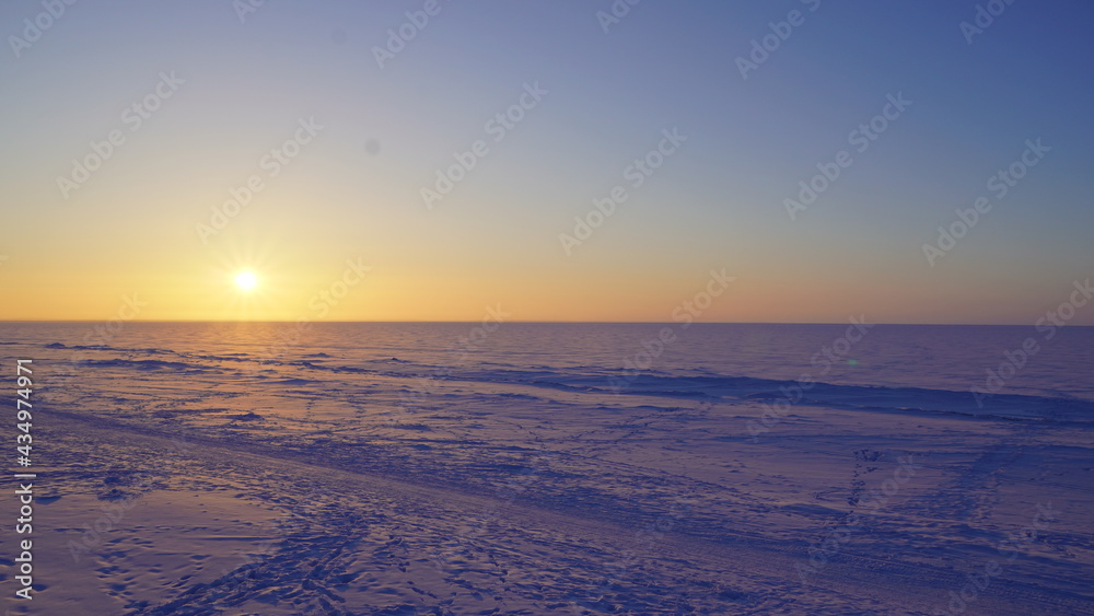 sunset in the winter on the white sea
