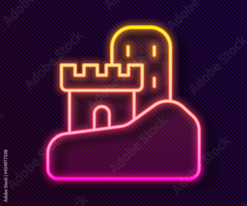 Glowing neon line Sand castle icon isolated on black background. Vector