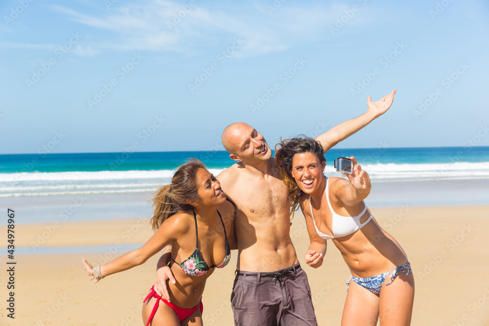 Happy multiracial friends taking a selfie at seaside Happy multiracial friends taking a selfie at seaside