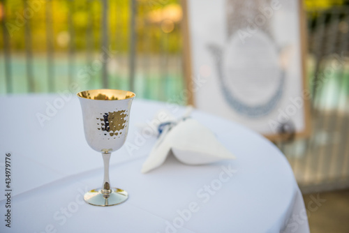 Fotografi Jewish wedding tradition custom of Kiddush cup filled with juice or wine for cer