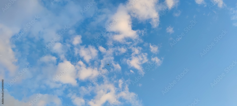 White and light gray clouds on the blue sky. On a clear sunny day, there are several high cumulus clouds against the backdrop of a clear, light blue sky. Clouds of different shapes and sizes. White and light gray clouds on the blue sky. On a clear sunny day, there are several high cumulus clouds against the backdrop of a clear, light blue sky. Clouds of different shapes and sizes.