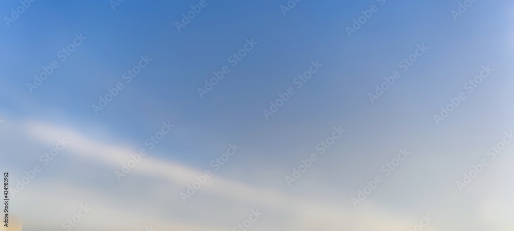 White translucent clouds against the blue sky. On a clear winter day, cirrus clouds are against the background of a clear light blue sky. Clouds are almost invisible against the sky.