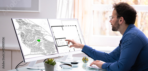 Developer Looking At Land Plot Map