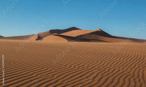 namibian desert sand dunes with waves in the sand in foreground