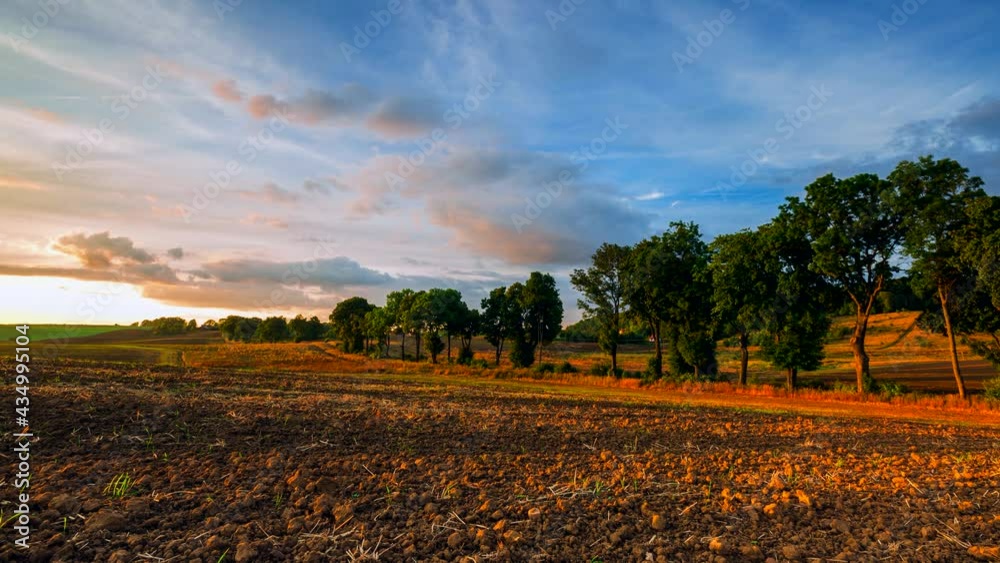 4k time lapse with sunset sky over plowed field and country side. 4k time lapse with sunset sky over plowed field and country side.