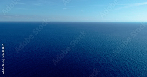Aerial view with a drone the Mediterranean Sea with only the blue water all over the horizon 4K