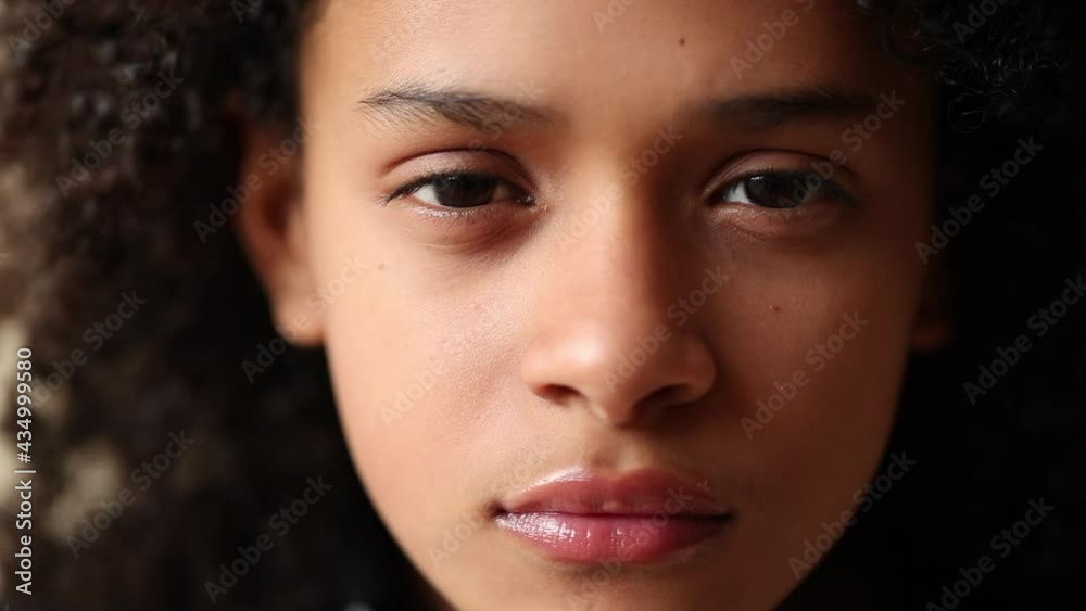 Hispanic child girl face looking at camera. Serious pre-teen latina Hispanic child girl face looking at camera. Serious pre-teen latina