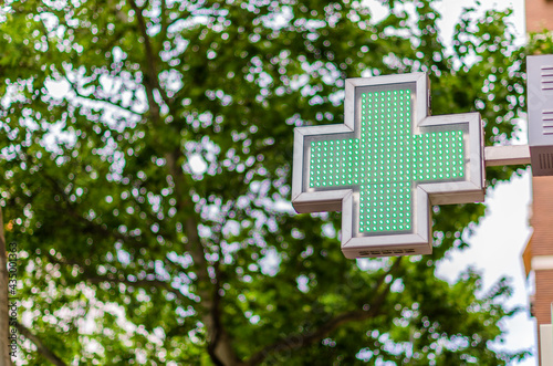 Green cross sign indicating pharmacy