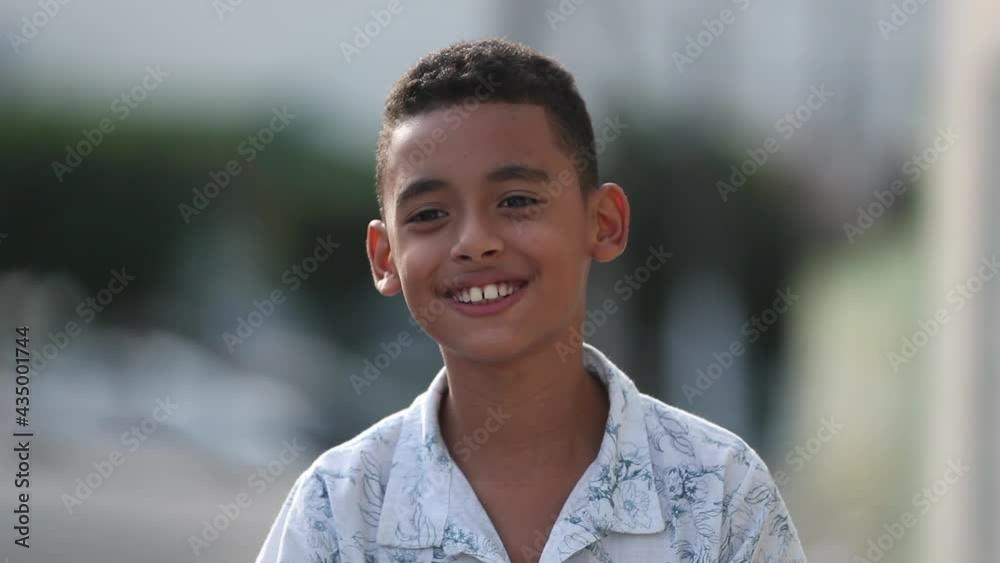 Hispanic child smiling outside. Young boy little kid portrait face close-up Hispanic child smiling outside. Young boy little kid portrait face close-up