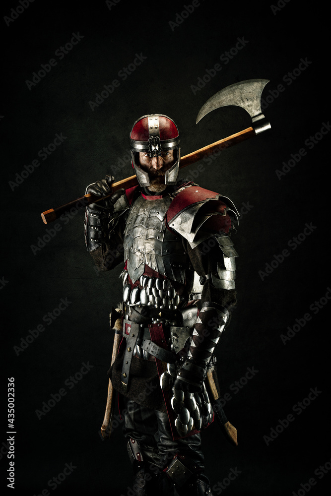 Naklejka premium Portrait of a medieval fighter carrying an ax over his shoulder
