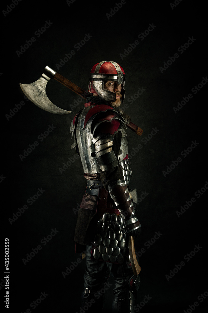 Portrait of a medieval fighter carrying an ax over his shoulder