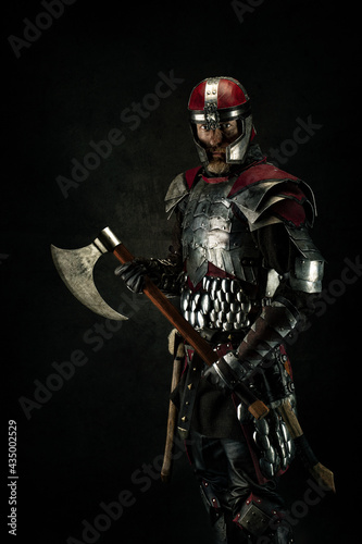Portrait of a medieval fighter holding an ax in his hands