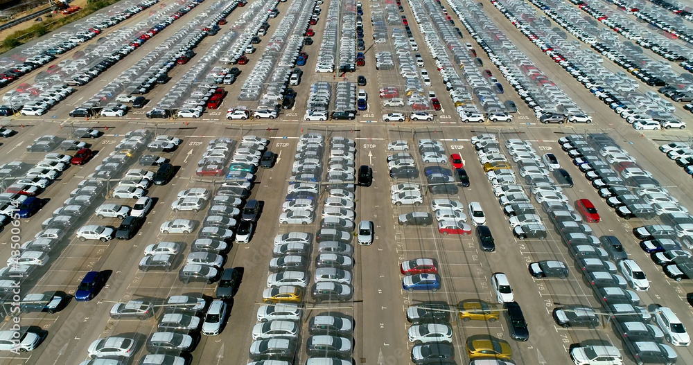 Aerial view above many white cars parked in a parking lot in daytime. Wonderful view with a drone in parking in Spain 4K Aerial view above many white cars parked in a parking lot in daytime. Wonderful view with a drone in parking in Spain 4K