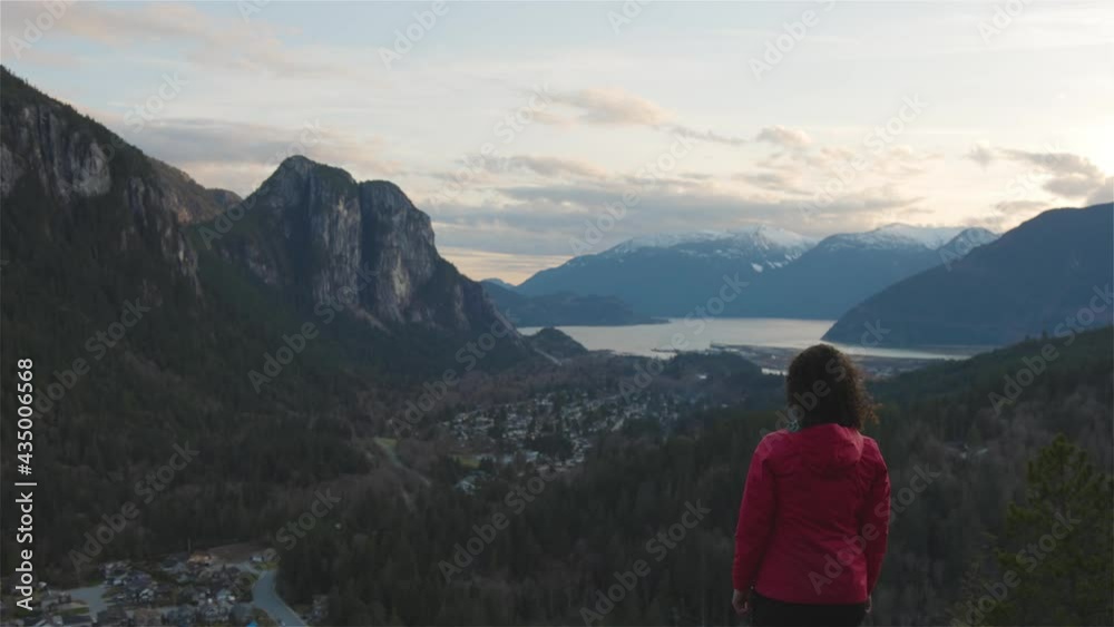 Adventurous Woman Hiking in the mountains during a Spring Sunset. Taken Squamish, North of Vancouver, British Columbia, Canada. Concept: Adventure, freedom, lifestyle Adventurous Woman Hiking in the mountains during a Spring Sunset. Taken Squamish, North of Vancouver, British Columbia, Canada. Concept: Adventure, freedom, lifestyle