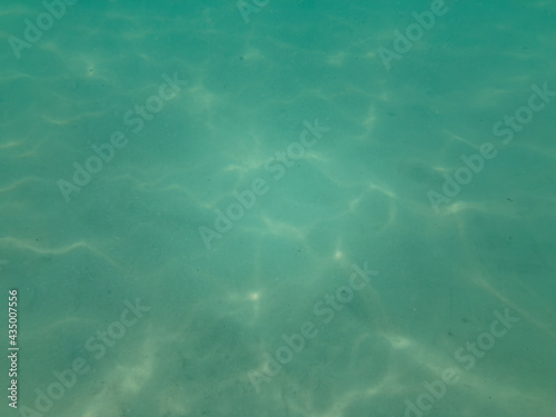 teal blue underwater ocean beach floor blured