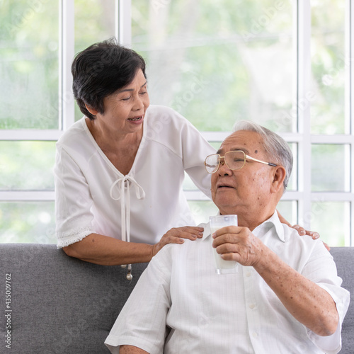 Senior old Asian man and woman lovers holding a glass of milk and drinking together. Idea for the healthcare of elder people