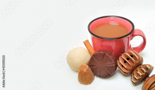 Fotografie Champurrado drink, whiskey (molinillo) and ingredients, artisan chocolate cinnamon dough and (piloncillo)
