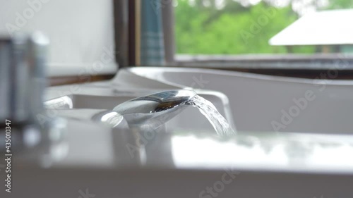 Whirlpool tub being filled with hot water in a hotel spa.
Slide panning shot in 4K